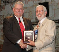 Ron Jarnagin (left), president of ASHRAE, congratulates Jim Newman on receiving the Distinguished Service Award at the ASHRAE Annual Conference. 