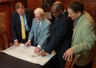 Bud Liebler, Jim Newman, Tupac Hunter and Andy Levin look at PACE energy efficiency upgrade plans for The Whitney 